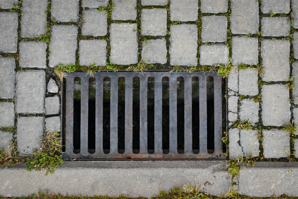 istock iron culvert on cobblestone street 1225590738