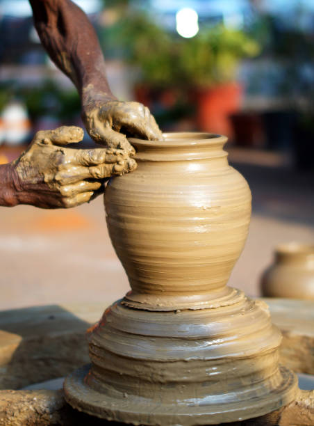 close-up of indian potter making an earthen pot on pottery wheel - earthenware imagens e fotografias de stock