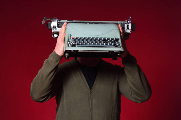 istock Portrait of a man holding an object on red 1225592448