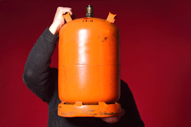 istock Portrait of a man holding an object on red 1225592507