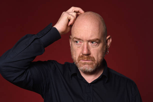 istock Portrait of a man on red 1225592691