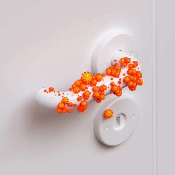 white door handle contaminated with finger prints of enlarged orange corona viruses