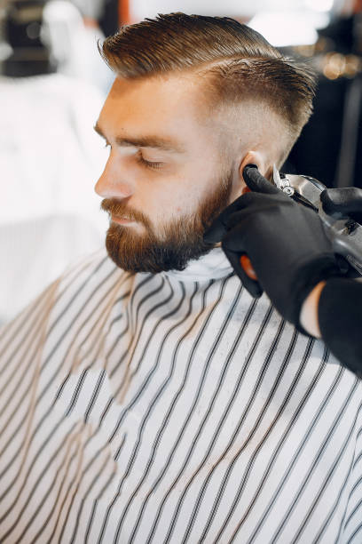 istock Stylish man sitting in a barbershop 1225593278
