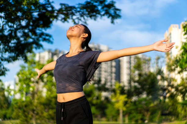 istock Asian millennial embracing nature with open arms. 1225593559