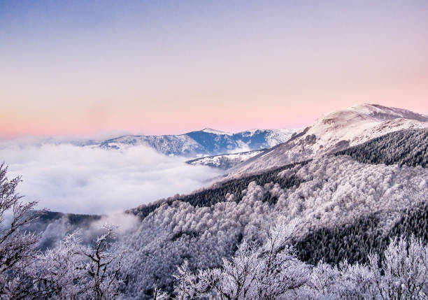 istock Purple sunset behind the snowy mountains 1225594462