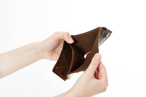 istock Female hand with an empty wallet isolated on white background, Bankruptcy 1225594475