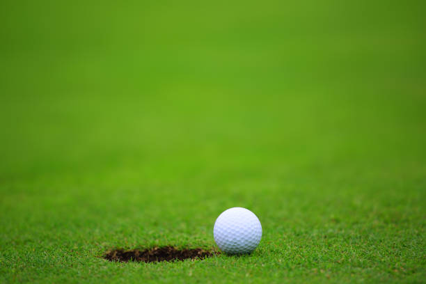 istock Golf ball close to hole 1225594545
