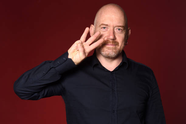 istock Portrait of a man on red 1225594561