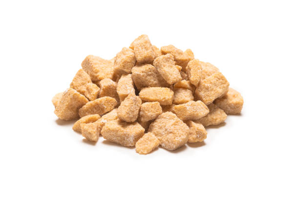 istock Brown sugar pieces isolated on white 1225594667