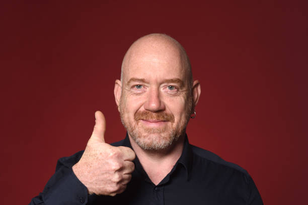 istock Portrait of a man on red 1225594705