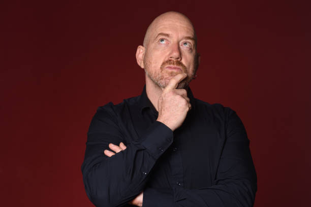 istock Portrait of a man on red 1225595057