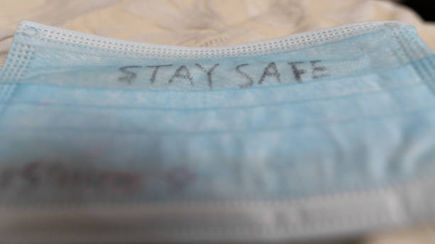 istock Face mask with a personal handwritten message 'stay safe' | virus protection 1225595257