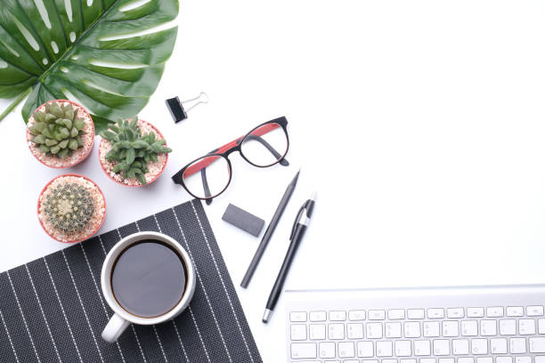 istock Flat lay top view office desk Workspace with computer keyboard, office supplies, pen, green leaf, eye glassesand,cactus,watches,and coffee cup on white background.jpg 1225596862