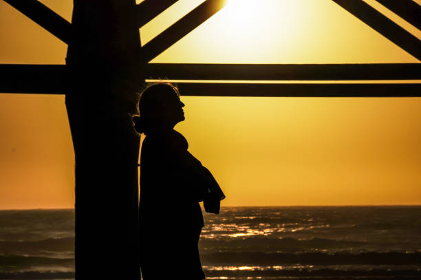 Woman walking on a bridge in a Californian sunset