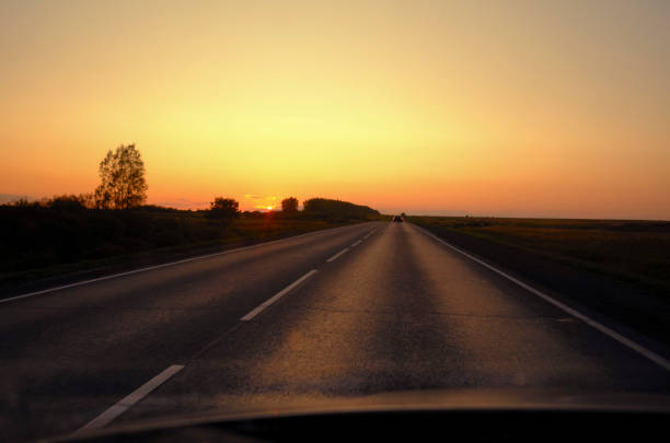 istock Sunset view from the car on the road 1225597047