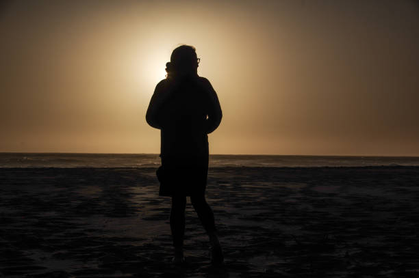istock Woman in sunset silhouette 1225597090