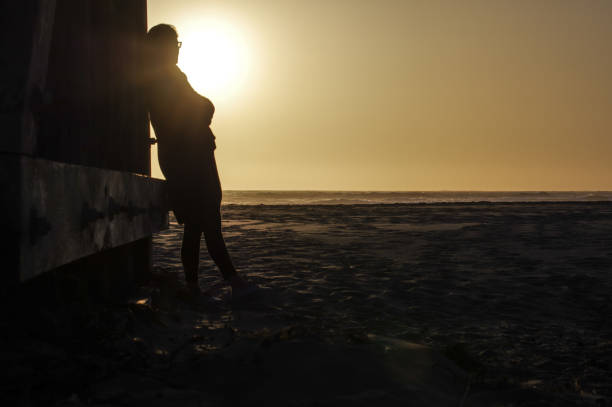 Woman walking on a bridge in a Californian sunset