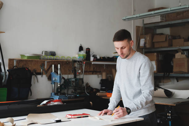 istock Portrait of a clothing designer or engineer at a generic workshop. 1225598157