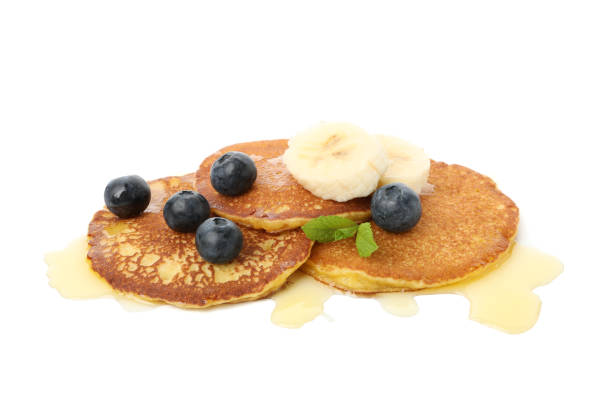 istock Tasty pancakes with honey and fruit isolated on white background 1225598513