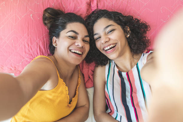 istock Mom and daughter having fun together in bed 1225600176