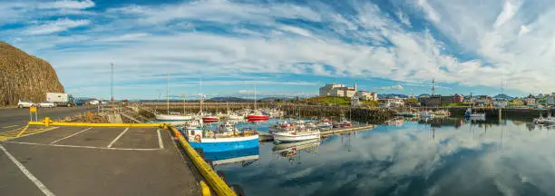 Panoramic view over sunset at Stykkisholmur (Stykkish) downtown and harbor with many fish restaurants, yachts, boats and a ferryboat towards Western Fjords, Iceland