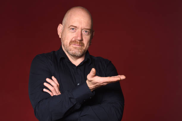 istock Portrait of a man on red 1225601462