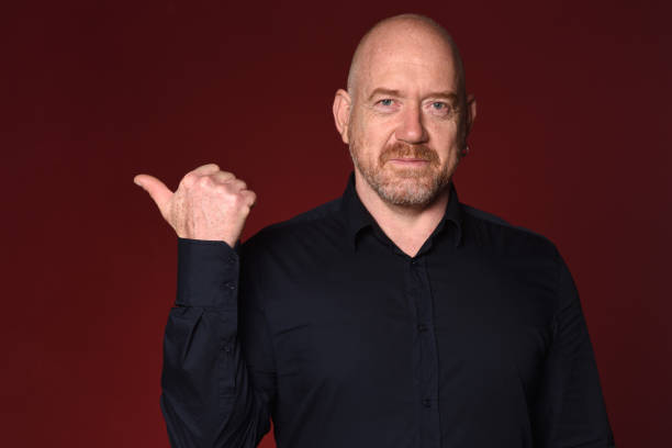 istock Portrait of a man on red 1225601493