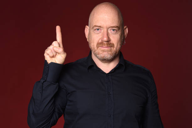 istock Portrait of a man on red 1225601516