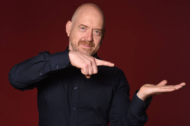 istock Portrait of a man on red 1225601578