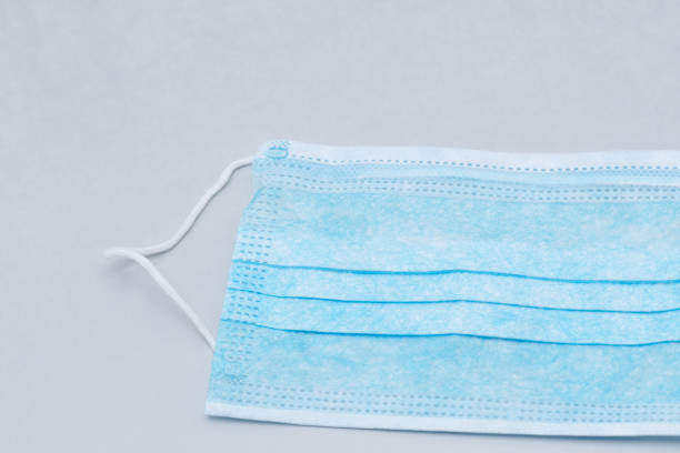 istock Blue medical mask on a gray background 1225601724