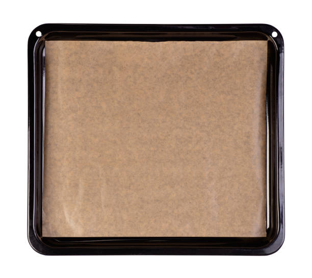 istock Baking tray with brown baking paper on white background 1225603304