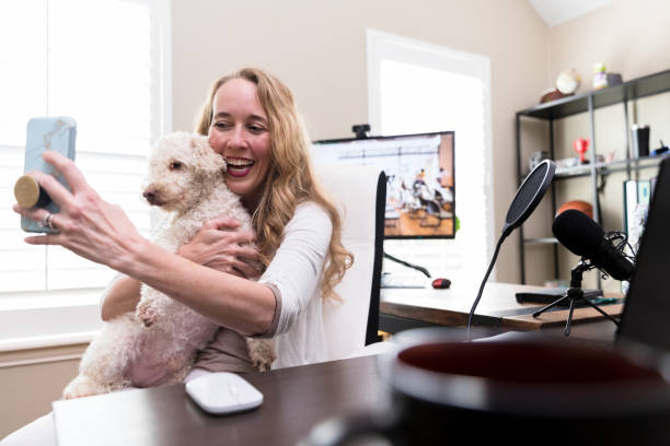 Happy woman taking selfie with her dog