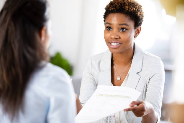 istock Mid adult therapist gives paperwork to unrecognizable client 1225603811