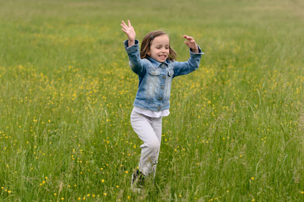 istock Child jumping in the field 1225605120