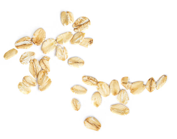 istock Oat flakes isolated on white background. Falling oats macro. Oatmeal Top view