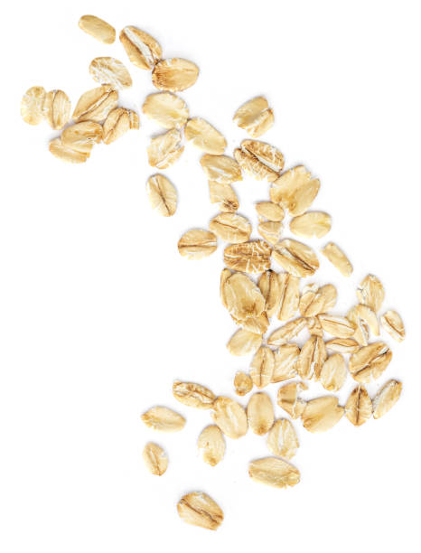 istock Oat flakes isolated on white background. Falling oats macro. Oatmeal Top view