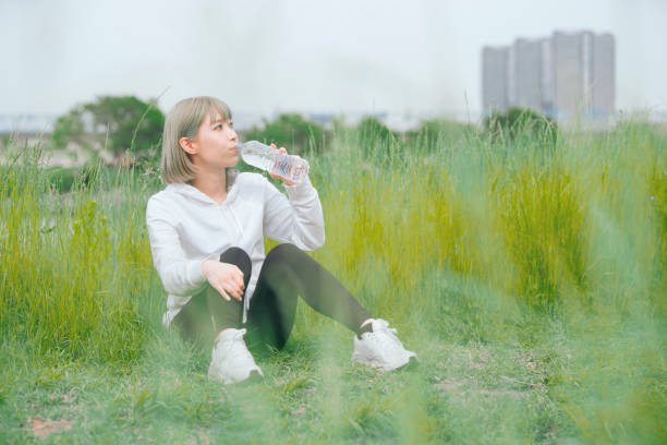 istock Asian young woman hydrating during exercise 1225605180