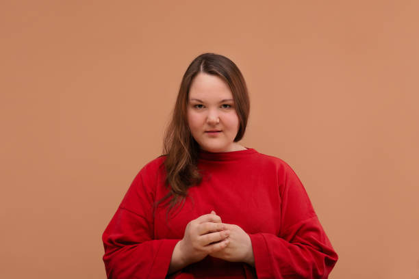 istock A nice overweight girl looks right into the frame. 1225605324