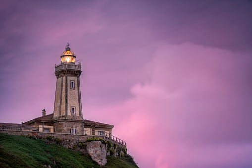 Aviles lighthouse (also known as San Juan lighthouse) at sunset in Asturias, Spain