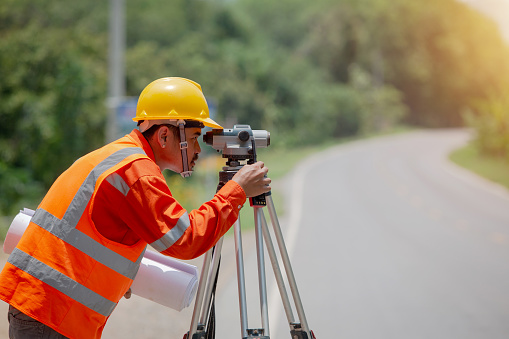 Surveyor marking road construction and land