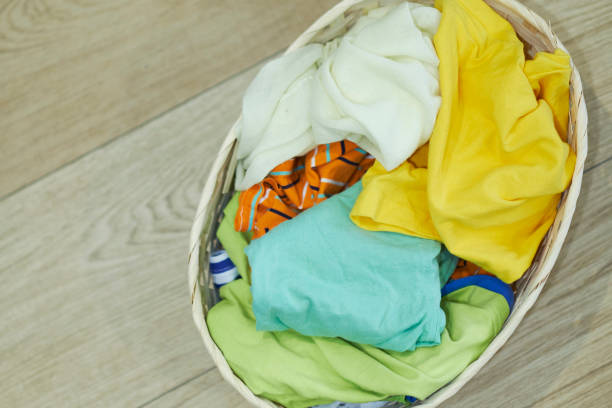 istock Top view Clothes in a laundry basket on Wood floor 1225609042