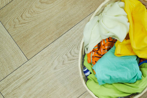 istock Top view Clothes in a laundry basket on Wood floor 1225609066