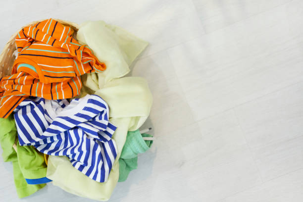istock Top view Clothes in a laundry basket on Wood floor 1225609139
