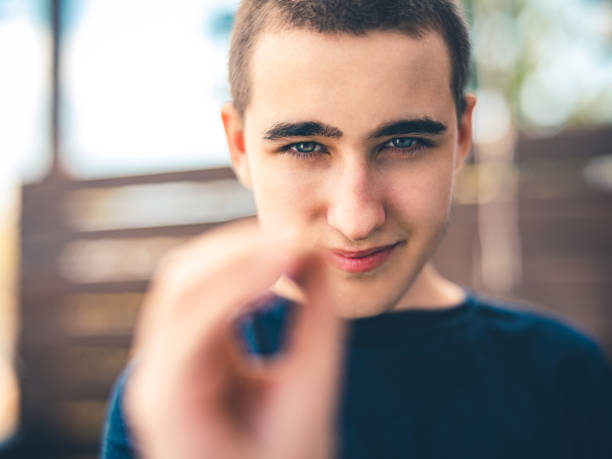 emotions of a handsome man guy on a green background chromakey close-up dark hair young man Portrait of a handsome young man against. High quality photo