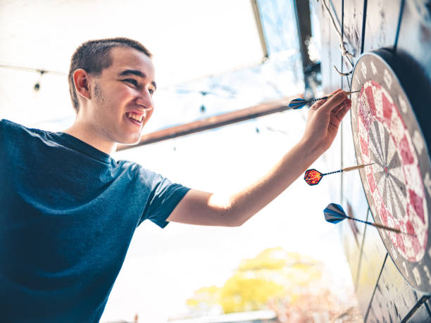 istock Teenager playing Darts outside 1225609403