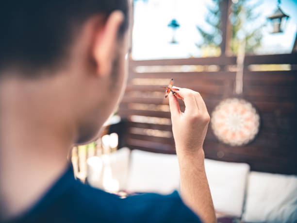 Teenager playing Darts outside