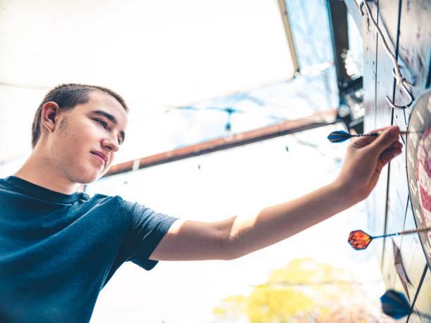 istock Teenager playing Darts outside 1225610237