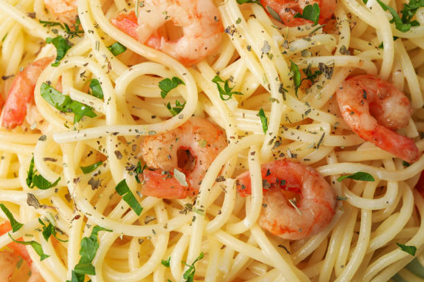 istock Tasty pasta with shrimps on whole background, close up 1225610329