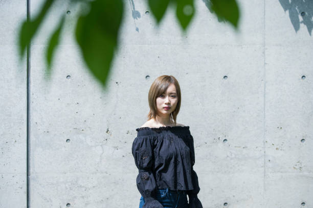 istock Asian young woman at sunny day 1225610835
