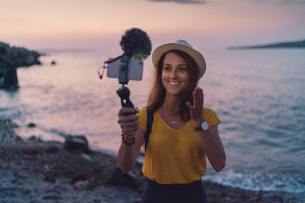 istock Young woman vlogging from beach holiday 1225610959